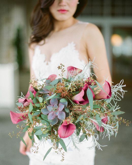 a lovely wedding bouquet of greenery, pink callas lilies, a purple succulent, berries and grasses is amazing