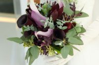 a moody wedding bouquet of deep purple blooms, greenery and burgundy blooms is a fantastic idea for a fall bride