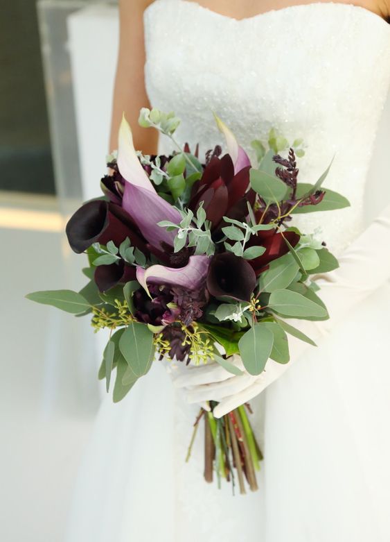a moody wedding bouquet of deep purple blooms, greenery and burgundy blooms is a fantastic idea for a fall bride