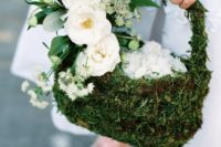 a moss flower girl basket decorated with white blooms and seeded eucalyptus is a stylish idea foa woodland wedding