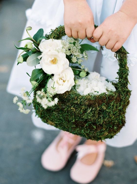 a moss flower girl basket decorated with white blooms and seeded eucalyptus is a stylish idea foa woodland wedding