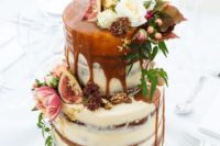a naked fall wedding cake topped with flowers and leaves, with figs and gold leaf plus caramel drip