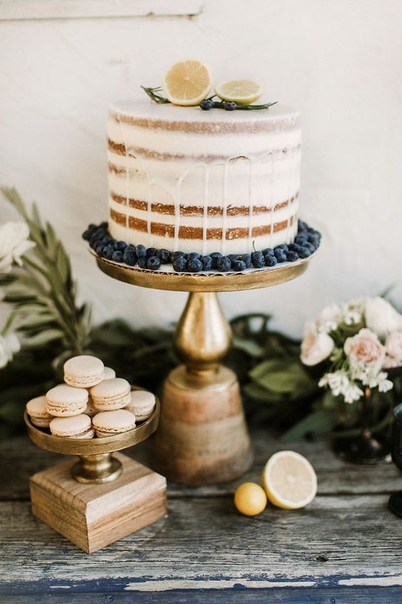 a naked wedding cake with citrus and blueberries for a cool summer wedding or a destination one