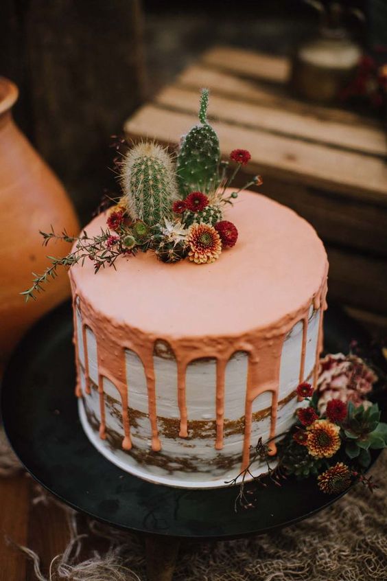 a naked wedding cake with copper drip, cacti and dried blooms on top is an amazing idea for a desert wedding