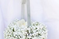 a pomander ball basket of baby’s breath and blue velvet ribbon is a chic and refined idea