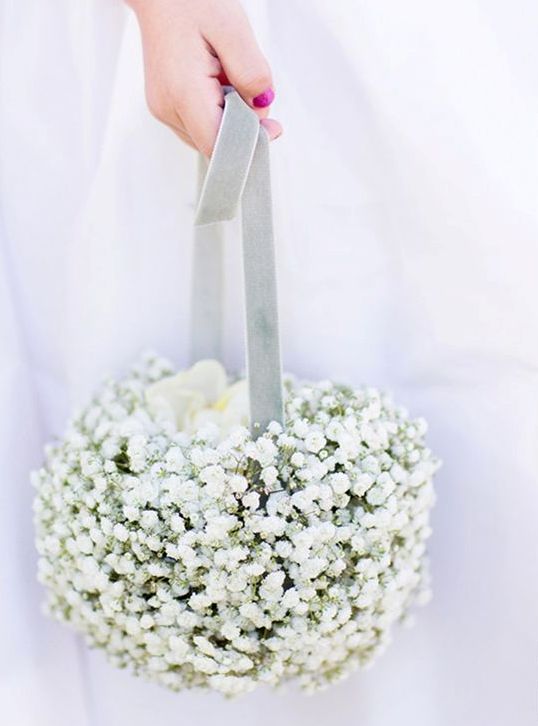 a pomander ball basket of baby's breath and blue velvet ribbon is a chic and refined idea