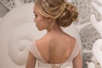 a refined and chic low bun of waves and curls, with a bump and an embellished headpiece is a beautiful solution for a formal wedding