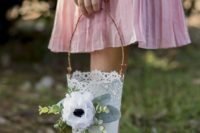 a romantic flower girl basket is designed with soft white anemone flowers and artificial greenery