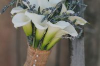 a rustic wedding bouquet of white callas, lavender and a burlap wrap with buttons is a lovely and out of the box idea