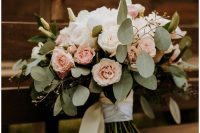 a simple and lovely wedding bouquet of white and blush roses and greenery plus long white ribbons is a very cool idea