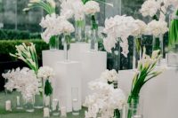 a sophisticated wedding altar of stands and acryl, white callas and orchids, candles in glasses and floating ones just wows