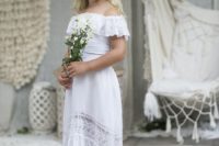 a super cute off the shoulder lace high low flower girl dress with lace inserts and a lace ruffle on the bodice