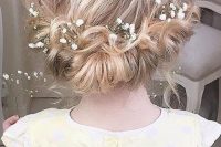 a twisted low updo with a messy top and some baby’s breath tucked in is a beautiful solution for medium length hair