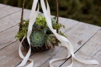 a vine basket with lots of succulents and a large ribbon bow is a trendy idea