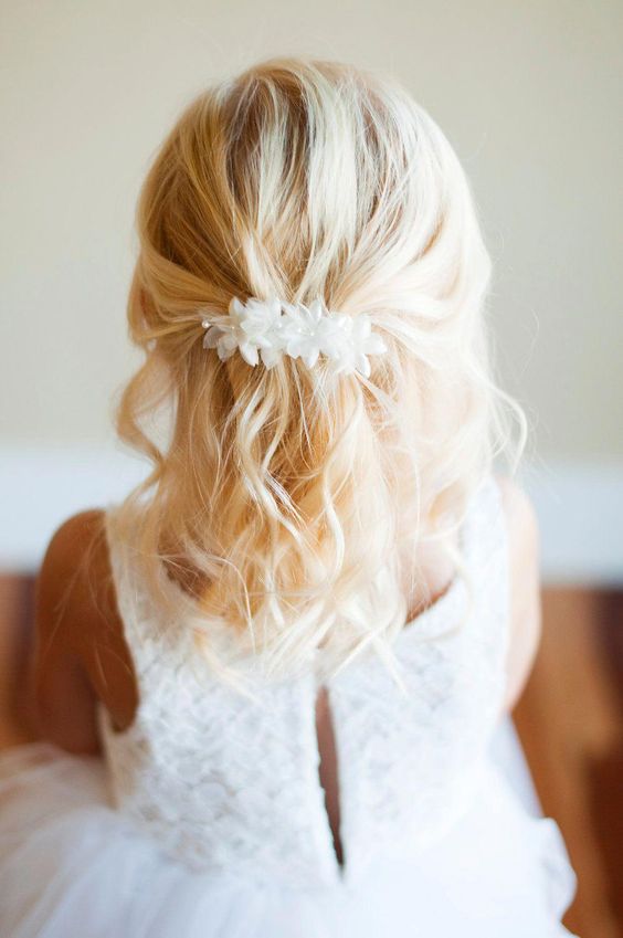 a wavy half updo with a voulminous bump, with waves down and a white silk flower hairpiece is a lovely idea that always works