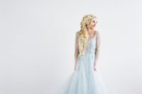 an Elsa-inspired bridal look with a blue wedding dress with a scopp neckline and a tulle skirt plus a dimensional loose Elsa braid