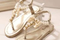 flat sandals with T straps decorated with pearls and silk bows are a chic and bold idea for a summer wedding