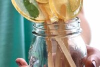 large citrus slice and mint lollipops are a fantastic refreshing idea for a summer wedding, they make your guests feel better