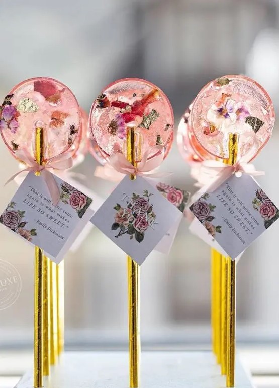 lovely pink dried flower lollipops with gold sticks and tags are fantastic wedding favors or escort card holders