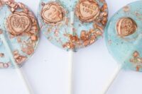 mint blue lollipops with copper pieces adn copper hearts with words are perfect for any wedding in any season