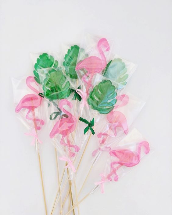 monstera leaves and pink flamingo lollipops are perfect to give them as tropical wedding favors