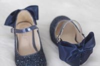 navy glitter strap flat shoes with silk bows on the backs will add color and chic to the look
