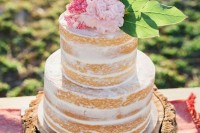 a spring or summer naked wedding cake with pink and blush blooms and leaves is a cool idea