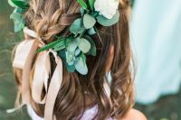 waves down plus a couple of braids on top, a greenery and white flower crown is a lovely solution for many flower girl looks