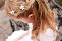 waves down with a braided halo and small flowers tucked in is a very cute and girlish idea to rock
