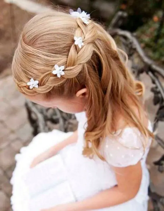 waves down with a braided halo and small flowers tucked in is a very cute and girlish idea to rock
