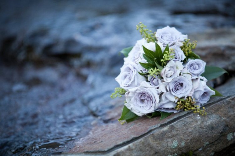 a simple wedding bouquet of serenity blue roses and seeded eucalyptus is a very catchy and outstanding idea