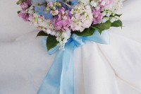a pretty wedding bouquet featuring pink, serenity blue and white blooms and long blue ribbons is a very cool and bold idea for your bright wedding