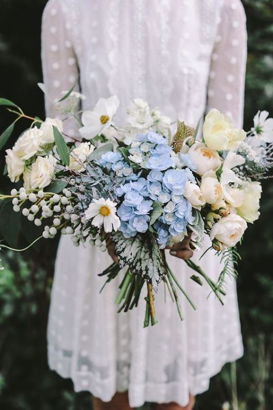 a dreamy lush wedding bouquet composed of serenity blue flowers and lots fo neutral ones, with berries and greenery is a pretty idea for a romantic spring wedding and your touch of something blue