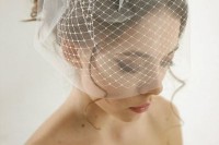 a birdcage veil with a bow is a pretty and elegant accessory for a lovely vintage-inspired bridal look