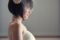 a mini birdcage veil with a fabric bloom is a lovely vintage-inspired accessory you may go for
