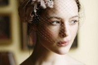 a birdcage veil with blush feathers as a headpiece is a lovely idea for a refined and chic bride
