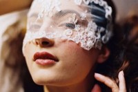 a lace headpiece put right on the face is a romantic and whimsical idea to add a chic touch to the look