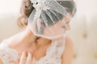 a mini veil decorated with crystals and topped with a refined embellished headpiece for a lovely and chic bridal look