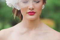 a mini veil with drapings and a fabric bloom on one side is a lovely idea for a modern and romantic bride