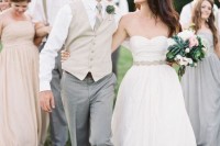 an elegant groom’s outfit with grey pants, a white button down, a tan waistcoat and a striped tie