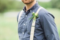a simple barn look with a chambray shirt, tan pants and suspenders and a floral boutonniere