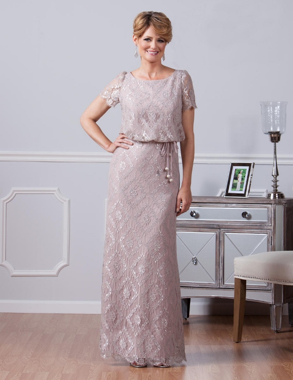 a blush sparkling maxi gown with a high neckline and short sleeves plus a sash with tassels for a delicate look