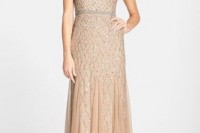 a peachy embellished gown with an illusion neckline and short sleeves looks chic and stylish