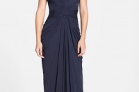 a midnight blue fittign maxi dress with a lace draped bodice, short sleeves and a draped skirt