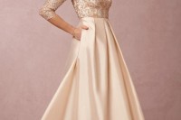 a neutral A-line maxi dress with an embellished bodice and a draped and shiny maxi skirt