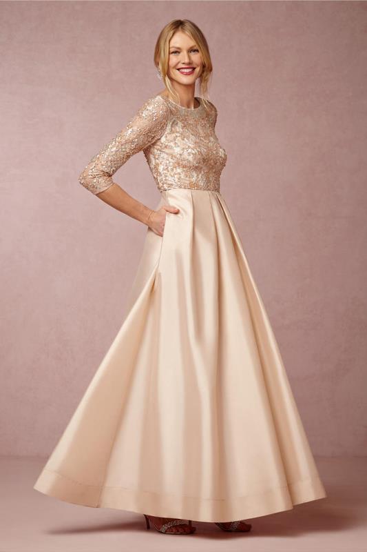 a neutral A-line maxi dress with an embellished bodice and a draped and shiny maxi skirt