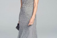 a heavily embellished grey maxi dress with a high neckline and no sleeves looks very festive and sparkling