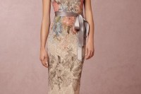 a fitting floral maxi dress with pastel embroidery, short sleeves, a high neckline and a silk grey sash