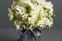 an elegant white freesia wedding bouquet with grey ribbon is a stylish and cool idea for a spring or summer wedding