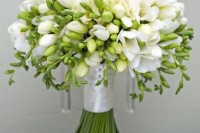 a white wedding bouquet of freesias and greenery is a lovely idea for an elegant and chic bride